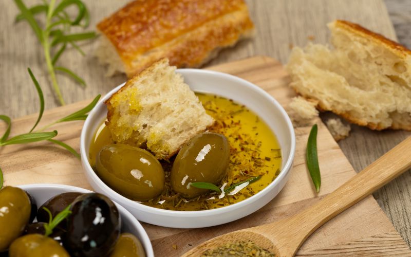 dipping bread in evoo